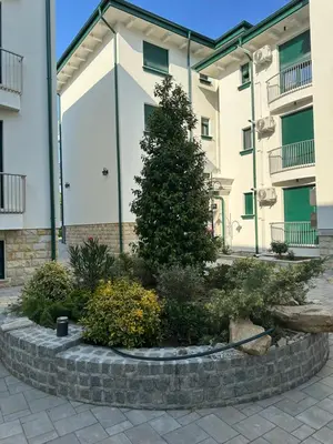 a christmas tree in front of a building at Luxury Stay in Vrnjačka Banja C2 in Vrnjačka Banja