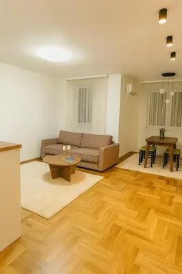 a living room with a couch and a table at Luxury Stay in Vrnjačka Banja C2 in Vrnjačka Banja