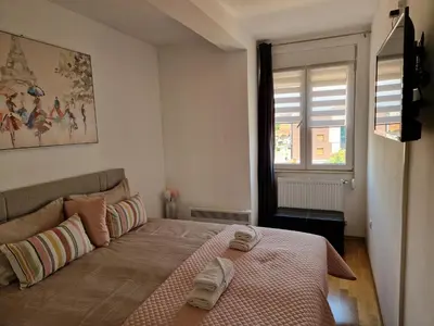 a bedroom with a bed with two towels on it at Apartman Iris in Pirot