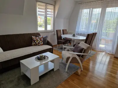 a living room with a couch and a table at Apartman Iris in Pirot