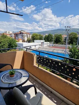 a table and chairs on a balcony with a view at Apartman Iris in Pirot