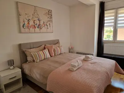 a bedroom with a bed with two towels on it at Apartman Iris in Pirot