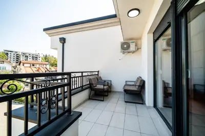 a balcony with chairs and a table on a building at Park Studio 19 in Vrnjačka Banja