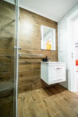a bathroom with a wooden wall at Park Studio 19 in Vrnjačka Banja
