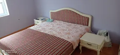 a bedroom with a bed with a red and white bedspread at DDS-Niš in Niš