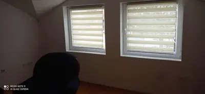 a room with two windows with blinds on them at DDS-Niš in Niš