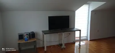 a flat screen tv sitting on a table in a room at DDS-Niš in Niš