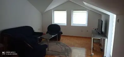 a living room with a couch and a television at DDS-Niš in Niš