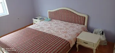 a bedroom with a bed with a red and white bedspread at DDS-Niš in Niš