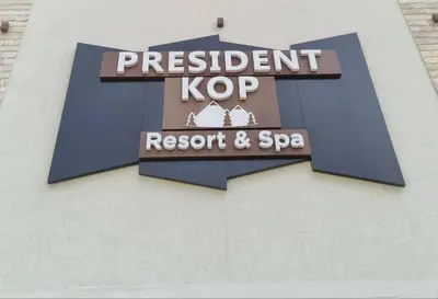 a sign for a restaurant and spa on the side of a building at Apartman President Kop in Kopaonik