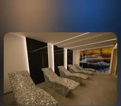 a row of chairs in a room with a painting at Apartman President Kop in Kopaonik