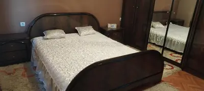 a bedroom with a bed and a mirror at Stamenkovic apartman in Vranje