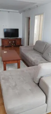 a living room with a couch and a flat screen tv at Stamenkovic apartman in Vranje