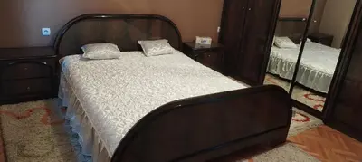 a bedroom with a bed and a mirror at Stamenkovic apartman in Vranje