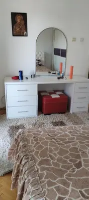 a bedroom with a dressing table and a mirror at Stamenkovic apartman in Vranje