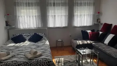 a living room with a bed and a couch at Studio apartman BB4 in Vrnjačka Banja