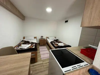 a small room with two beds and a kitchen at Studio x2 in Jošanička Banja