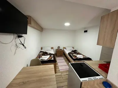 a small room with two beds and a kitchen at Studio x2 in Jošanička Banja