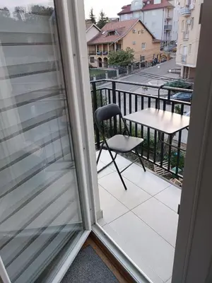 a balcony with a chair and a table at Lipa in Vrnjačka Banja