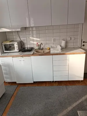 a white kitchen with a sink and a microwave at Lipa in Vrnjačka Banja