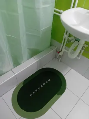 a bathroom with a shower and a black sink at Apartmani Stevanovic in Despotovac