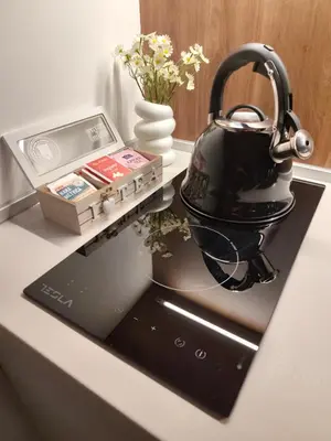 a tea kettle sitting on top of a stove at Daisy Apart SKI OUT SKI IN Vila Bela Reka Brzece in Brzeće