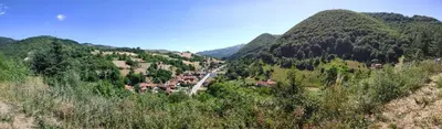 a winding road in a mountain valley with trees at Daisy Apart SKI OUT SKI IN Vila Bela Reka Brzece in Brzeće