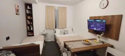 a small room with a bed and a table and a tv at Daisy Apart SKI OUT SKI IN Vila Bela Reka Brzece in Brzeće