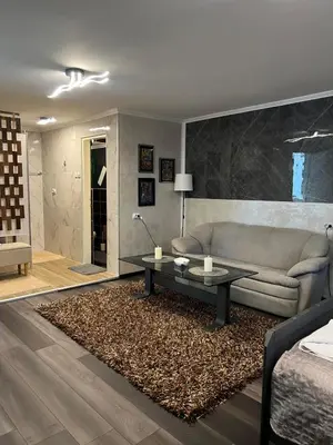 a living room with a couch and a coffee table at Diamona Lux Apartman 1 in Donja Toponica
