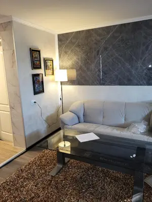 a living room with a couch and a table at Diamona Lux Apartman 1 in Donja Toponica