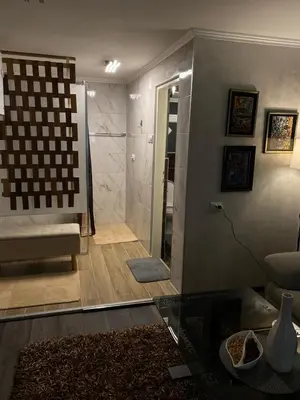 a bathroom with a shower and a glass table at Diamona Lux Apartman 1 in Donja Toponica