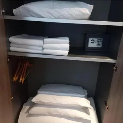 a closet with white towels and a pile of towels at Apartment Aleksandar AS in Brzeće