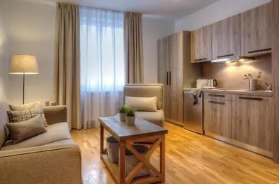 a living room with a couch and a table and a kitchen at Apartment Aleksandar AS in Brzeće