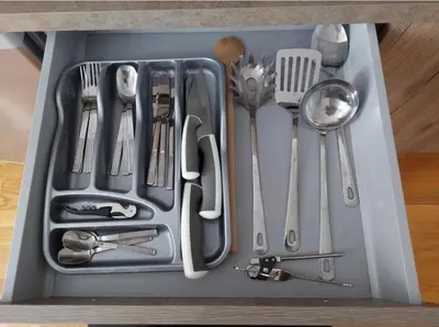 a tray filled with utensils sitting on a table at Apartment Aleksandar AS in Brzeće