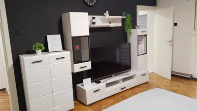 a large white entertainment center with a flat screen tv at Lela's home II in Knjazevac.