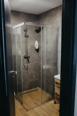 a shower with a glass door in a bathroom at SKY VIEW Apartment - Ski resort Kopaonik in Cajetina
