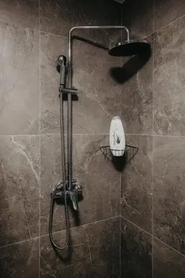 a shower with a shower head in a bathroom at SKY VIEW Apartment - Ski resort Kopaonik in Cajetina