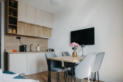 a kitchen and dining room with a table and chairs at SKY VIEW Apartment - Ski resort Kopaonik in Cajetina
