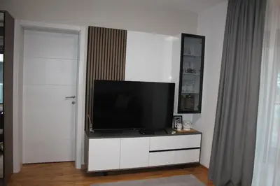 a television on a white dresser in a living room at Apartment Ornament Lux B11 in Vrnjačka Banja
