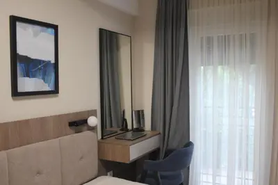 a hotel room with a bed and a mirror at Apartment Ornament Lux B11 in Vrnjačka Banja