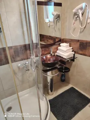 a bathroom with a sink and a shower at Sunce in Ribarska Banja