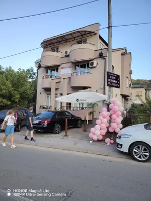 a group of cars parked in front of a building at Sunce in Ribarska Banja