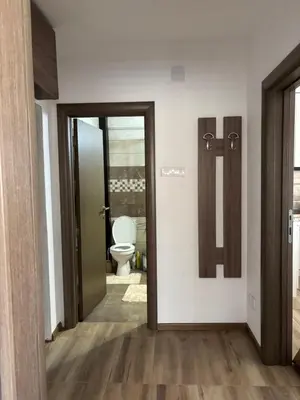 a bathroom with a toilet and a door leading into a room at Apartman A2 in Vrnjačka Banja