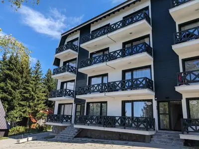 an apartment building with black and white balconies at Silverpine, Kopaonik in Kopaonik