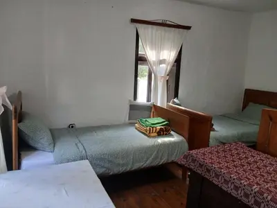 a small room with two beds and a window at KAMENICA Stara Planina in Dimitrovgrad