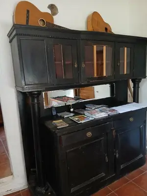 a black wooden cabinet with a desk with guitars at KAMENICA Stara Planina in Dimitrovgrad