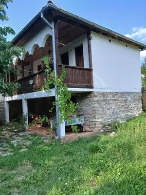 a house with a balcony on the side of it at KAMENICA Stara Planina in Dimitrovgrad