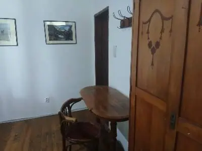 a room with a wooden table and a wooden door at KAMENICA Stara Planina in Dimitrovgrad