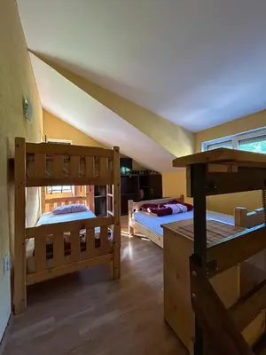 a bedroom with two bunk beds and a window at Smeštaj Miok in Soko Banja
