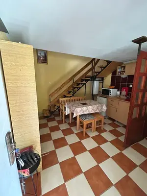 a living room with a table and a kitchen at Smeštaj Miok in Soko Banja